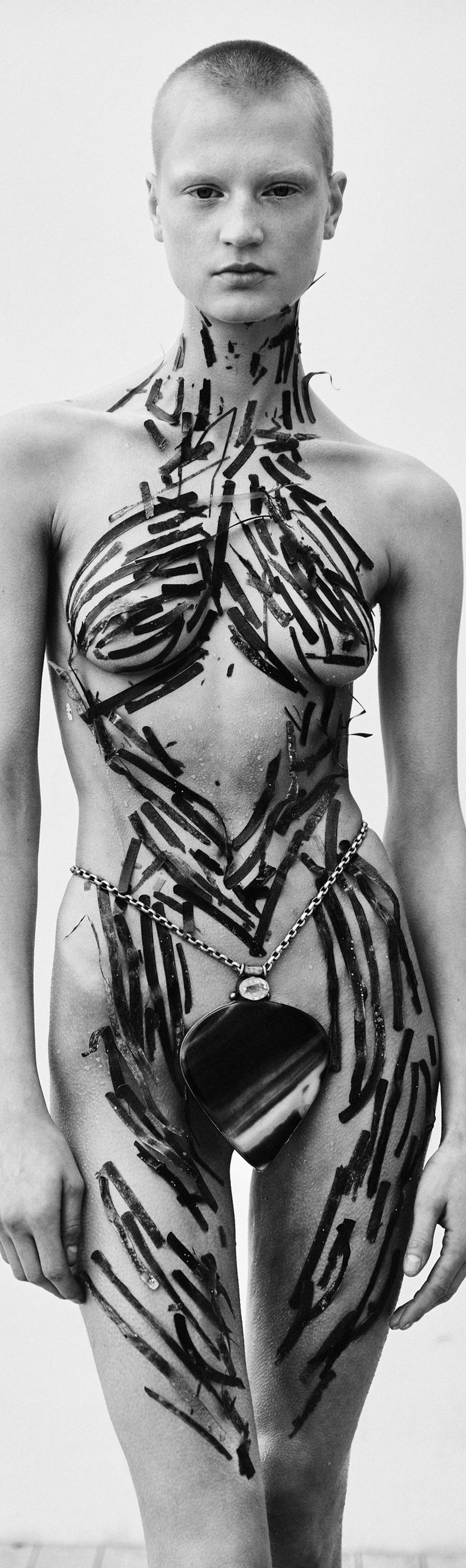 Body-painted figure, black and white editorial portrait